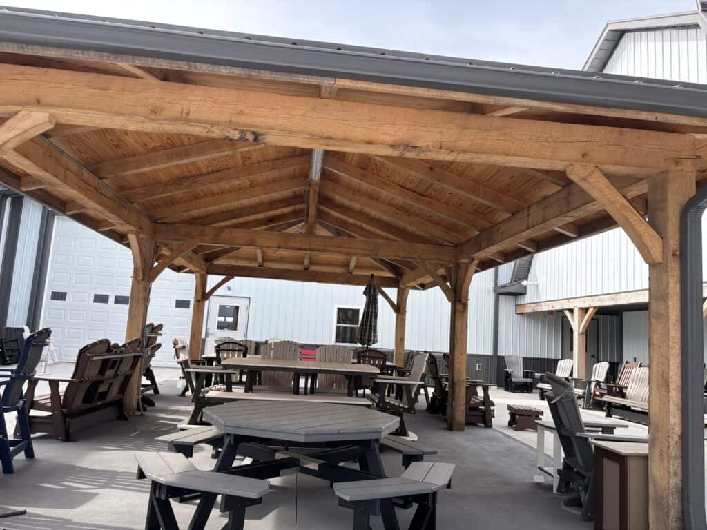Handcrafted Amish timber pavilion with exposed beams creating a beautiful backyard dining and gathering space.